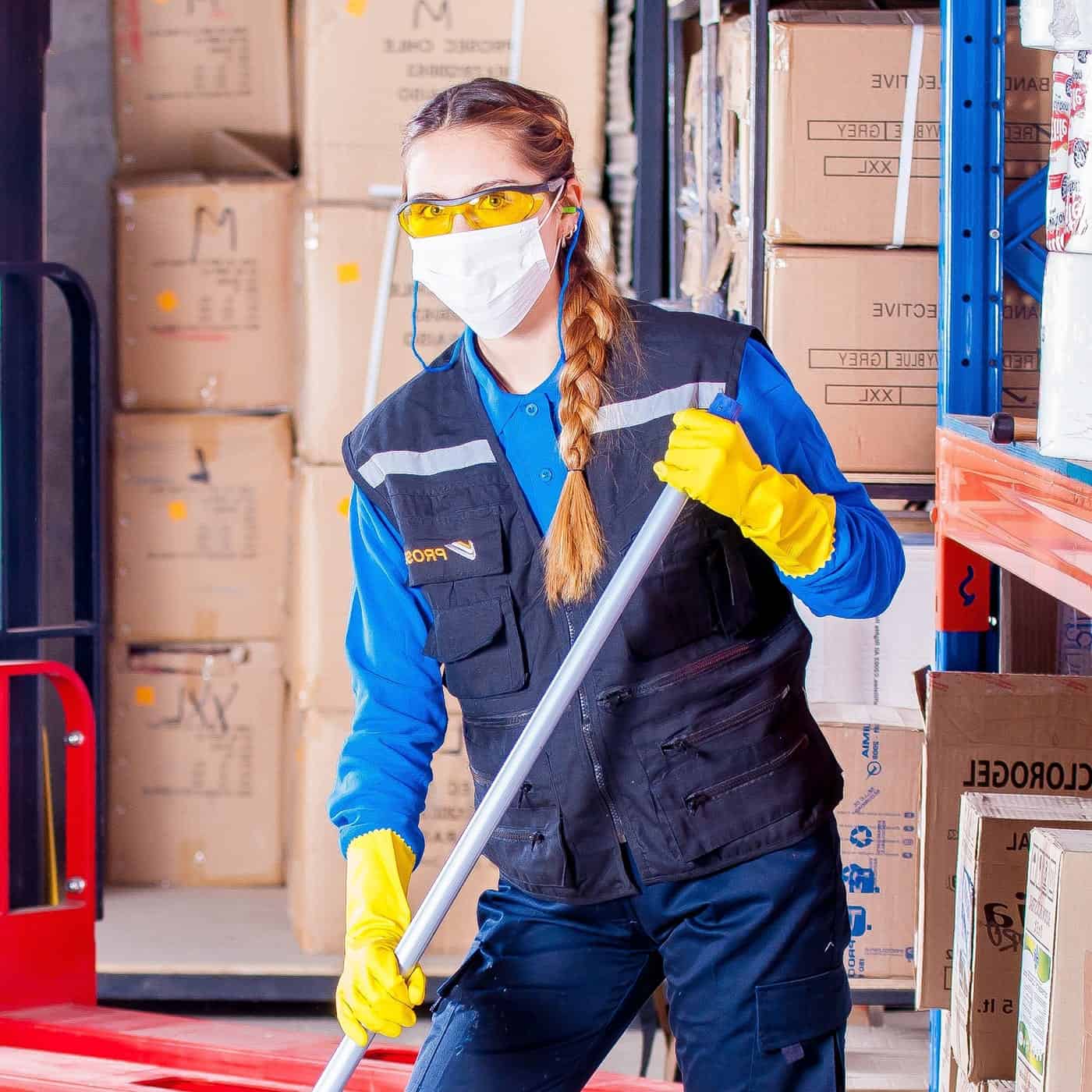 Cleaner mopping a warehouse